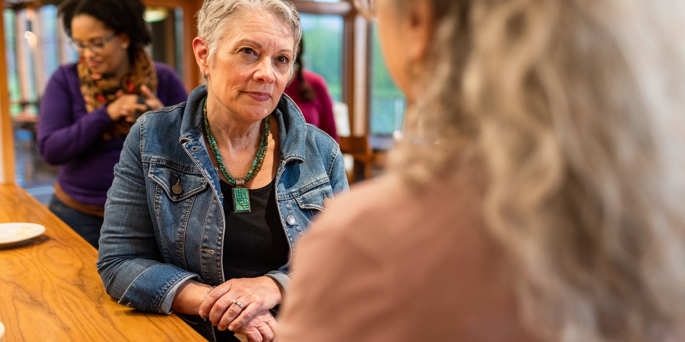Two participants in conversation during a break